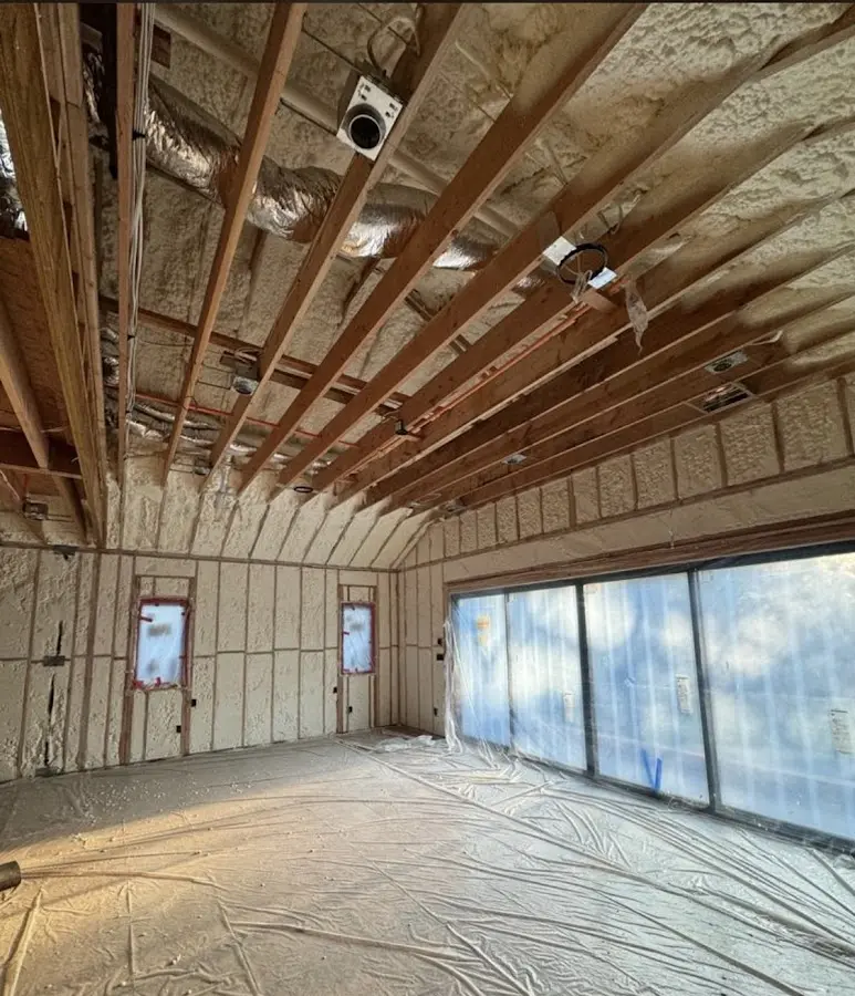 Interior walls and ceiling insulated with spray foam during new construction in Le Ray